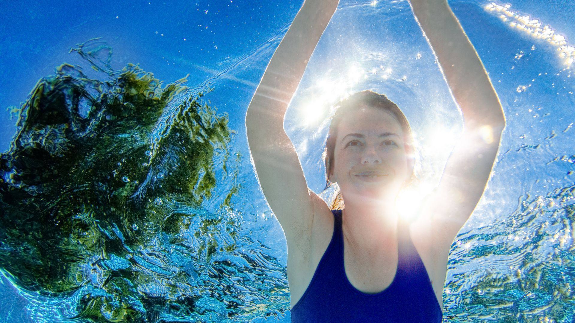 Woman swimming in an above-ground pool with a deep end